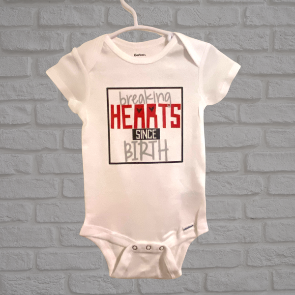 breaking hearts since birth onesie